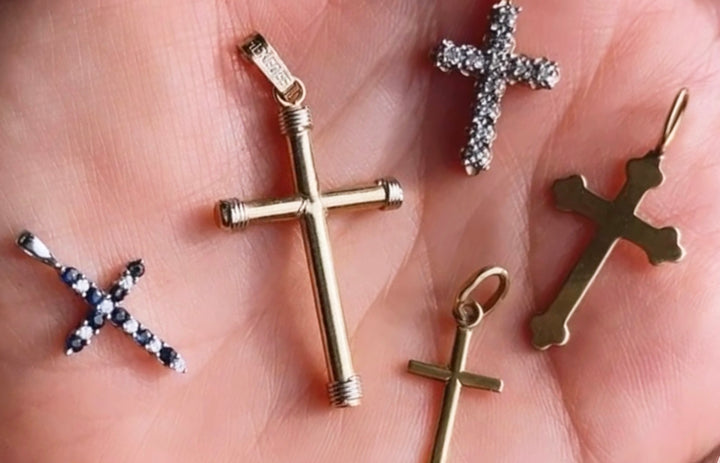 An assortment of vintage and antique crosses in 14k yellow gold and diamonds and sapphires