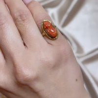 Video of Carved Orange Red Coral Cameo of Woman in Yellow Gold Ring Shown on Finger