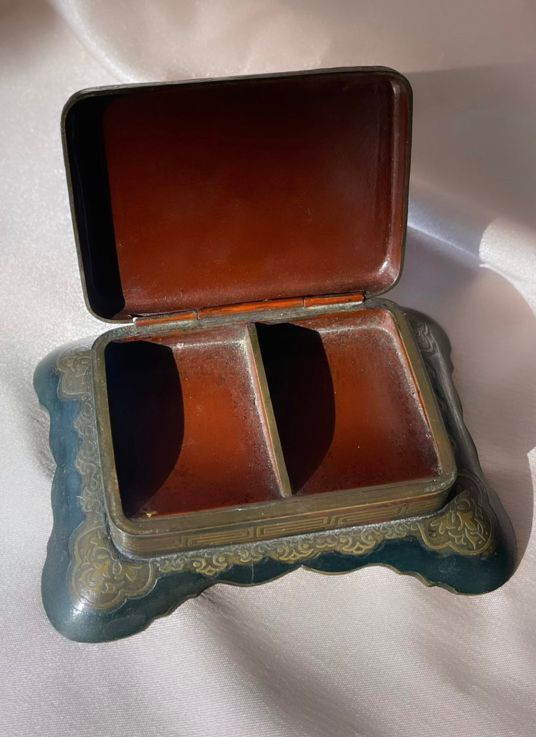 an antique Art Deco stamp box with decorative top and Greek key design