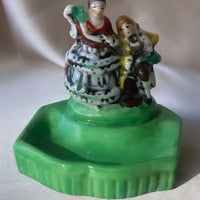 a vintage Japanese export porcelain ring or soap dish with two hand painted figures