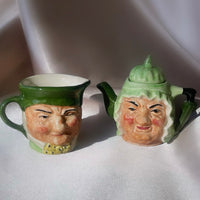 A pair of figural sculpted Charles Dickens character face tea pot and milk pourer, vintage and in porcelain