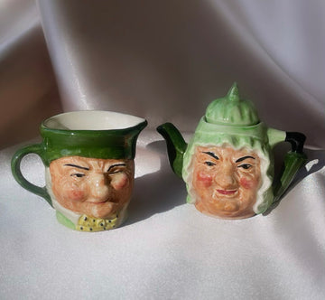 A pair of figural sculpted Charles Dickens character face tea pot and milk pourer, vintage and in porcelain