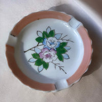 A vintage Japanese handpainted floral ashtray in pink green blue and white