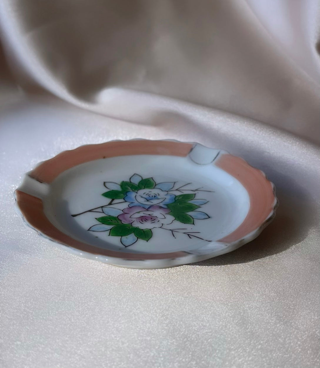 A vintage Japanese handpainted floral ashtray in pink green blue and white