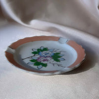 A vintage Japanese handpainted floral ashtray in pink green blue and white