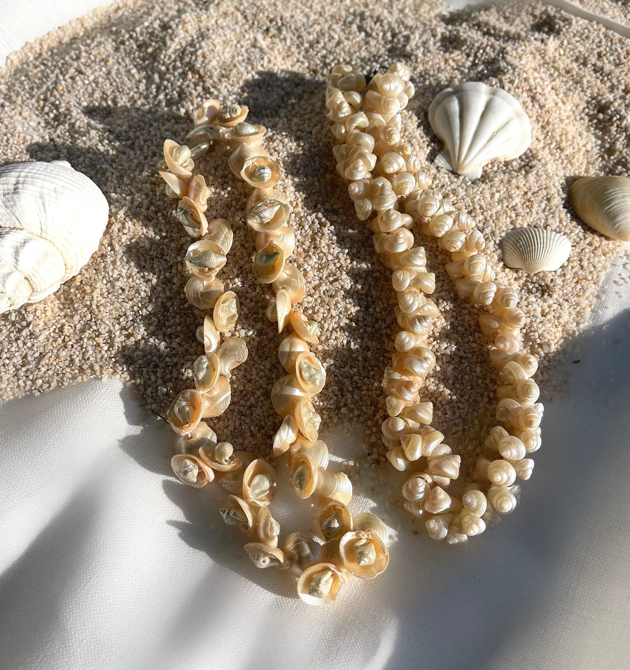 A photo of two vintage 1950s Mid Century era shell bead choker necklaces