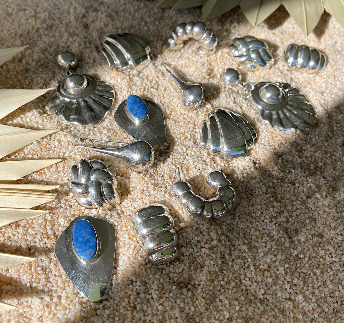 A selection of sterling silver vintage earrings, some with blue stones, with sand