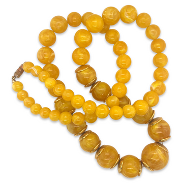 A yellow and orange plastic vintage 1950s Mid Century era beaded long necklace