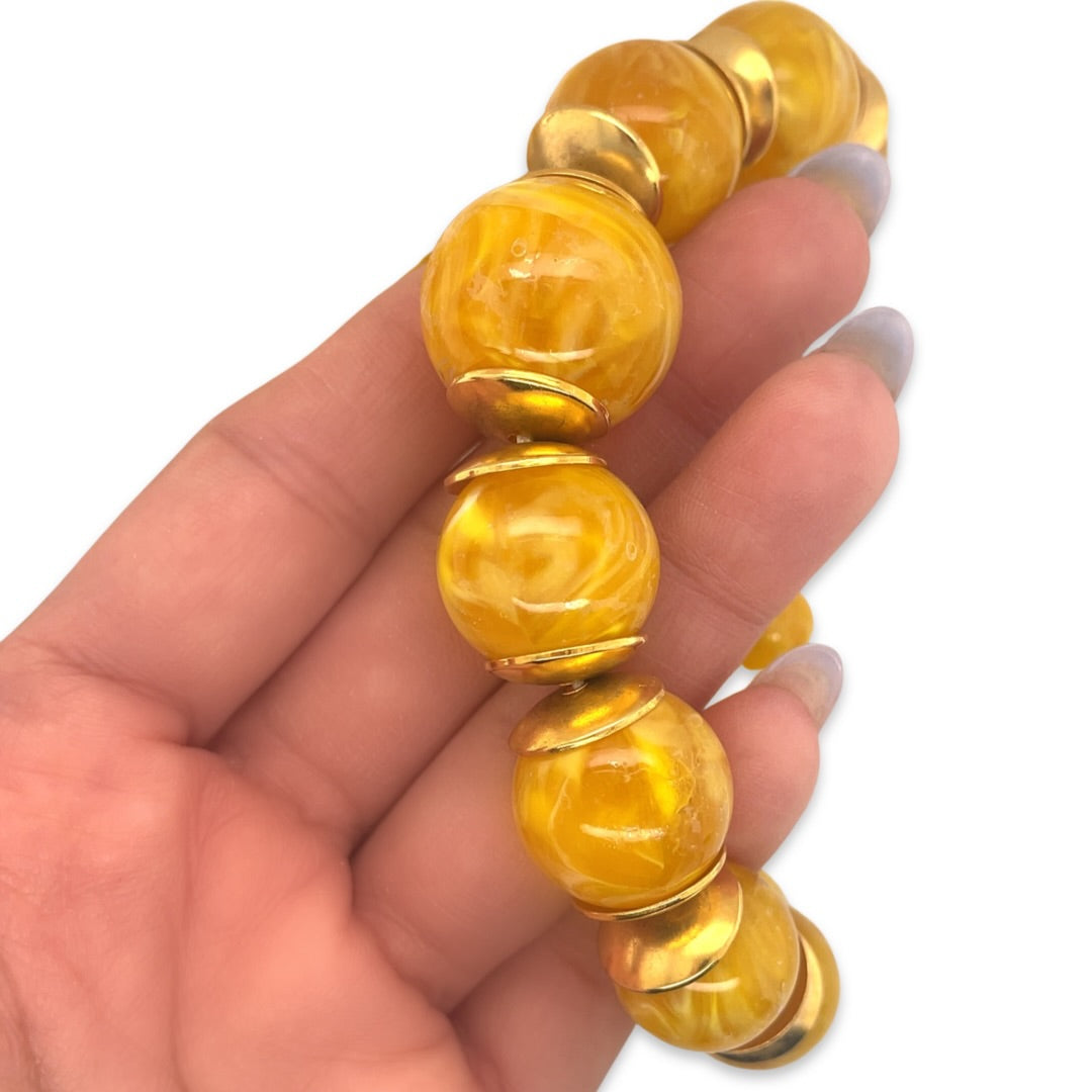 A close-up of a vintage 1950s Mid Century era orange and yellow beaded necklace
