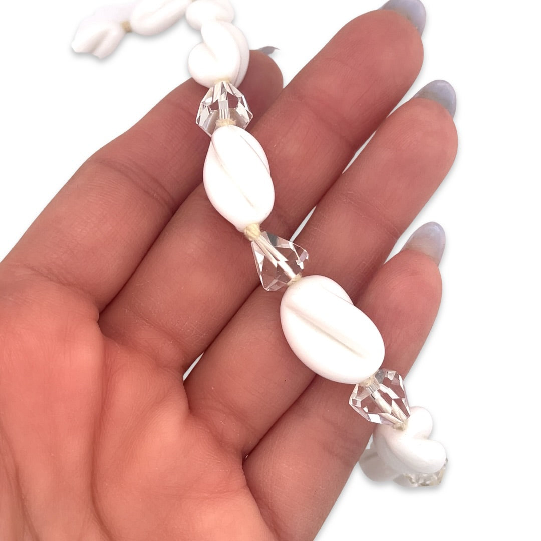 A close up of a vintage 1950s Mid Century era white ceramic and crystal beaded necklace
