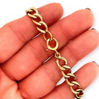 Vintage 14k Yellow Gold 7.5-Inch Cuban-Link Bracelet with Spring Ring Clasp in hand