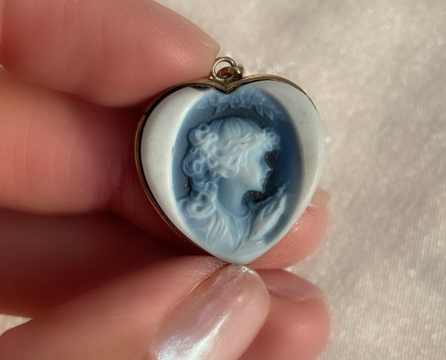 a white and blue Wedgwood jasperware porcelain cameo of a woman in the shape of a heart pendant set in yellow gold