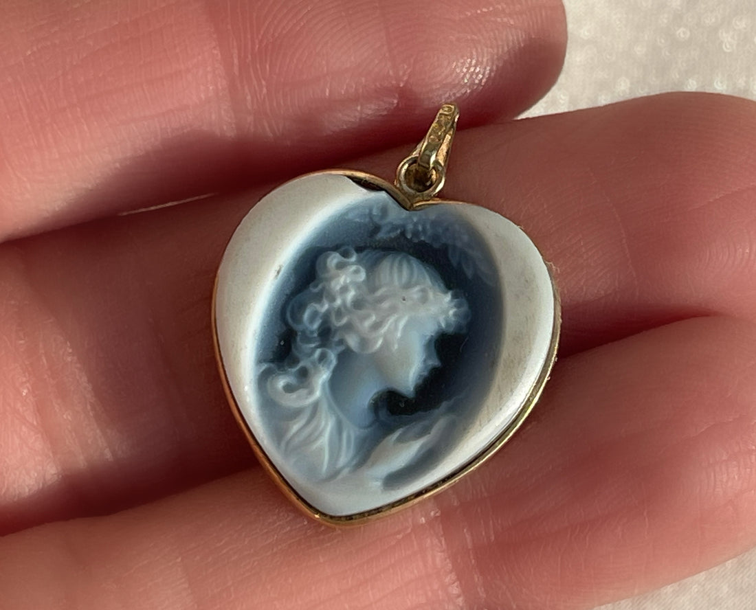 a white and blue Wedgwood jasperware porcelain cameo of a woman in the shape of a heart pendant set in yellow gold
