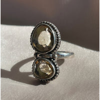 A large vintage sterling silver ring with two faceted yellow citrine stones