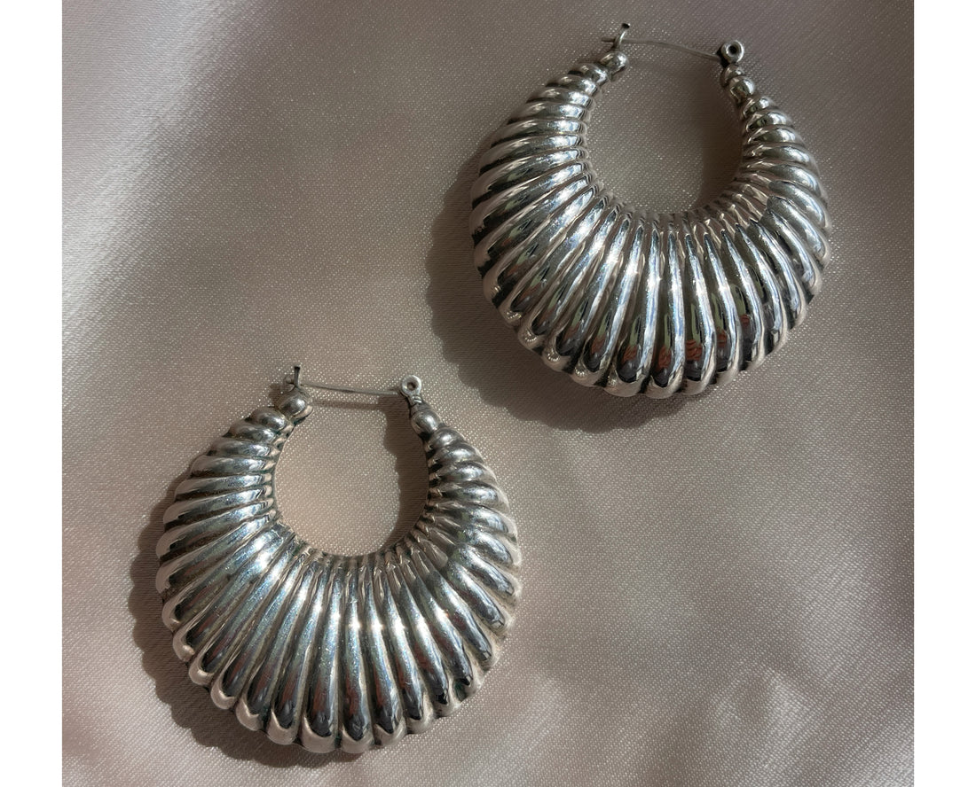 A pair of vintage sterling silver puffy croissant-style textured hoop statement earrings