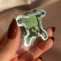 A vintage hand carved green jade frog with glass eyes set in sterling silver