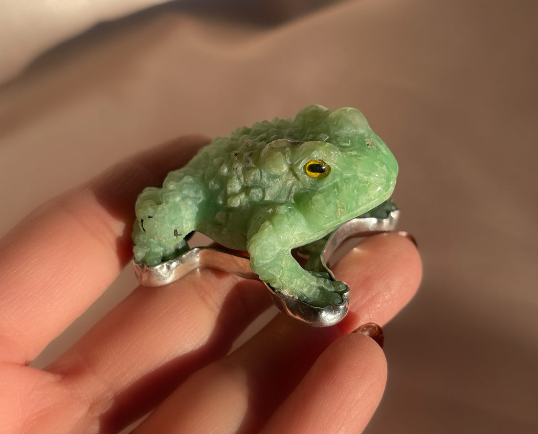 A vintage hand carved green jade frog with glass eyes set in sterling silver