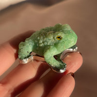 A vintage hand carved green jade frog with glass eyes set in sterling silver