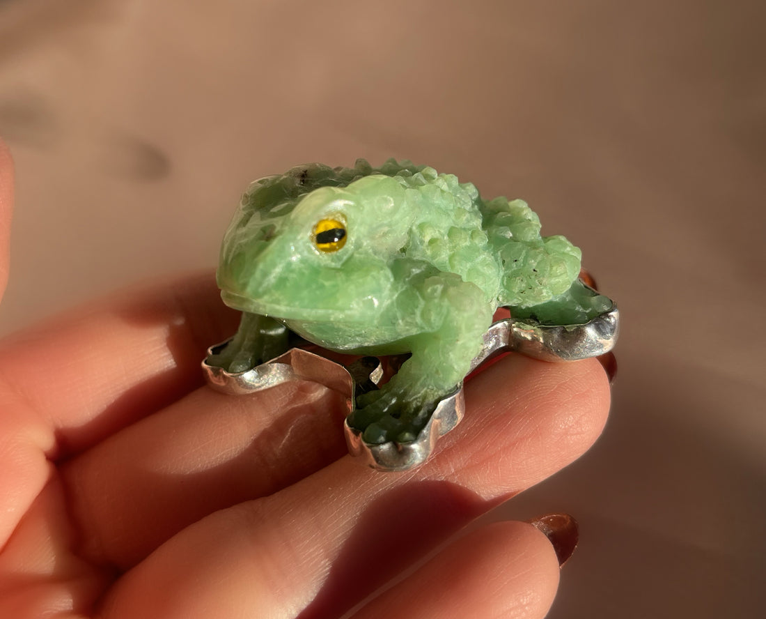 A vintage hand carved green jade frog with glass eyes set in sterling silver