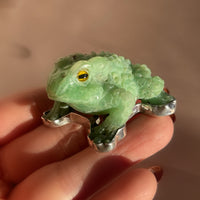 A vintage hand carved green jade frog with glass eyes set in sterling silver