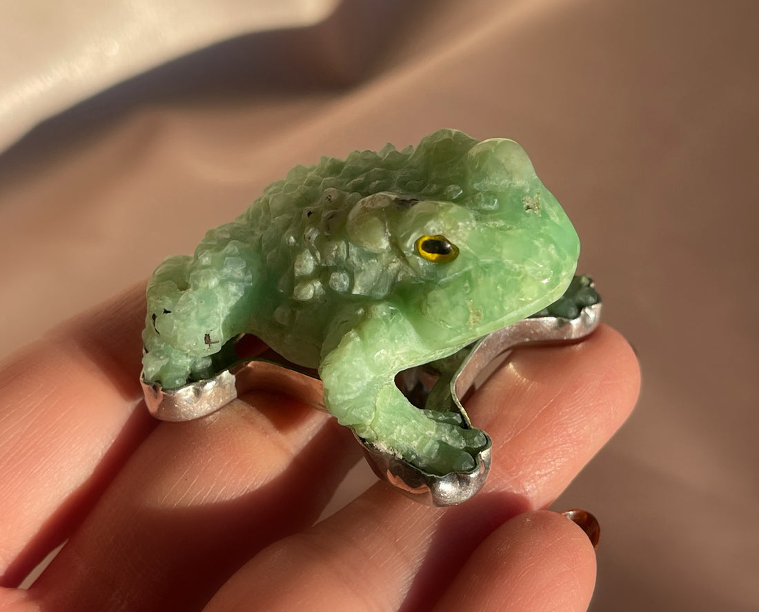 A vintage hand carved green jade frog with glass eyes set in sterling silver