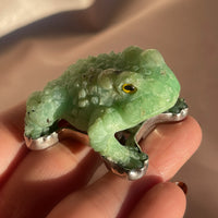 A vintage hand carved green jade frog with glass eyes set in sterling silver