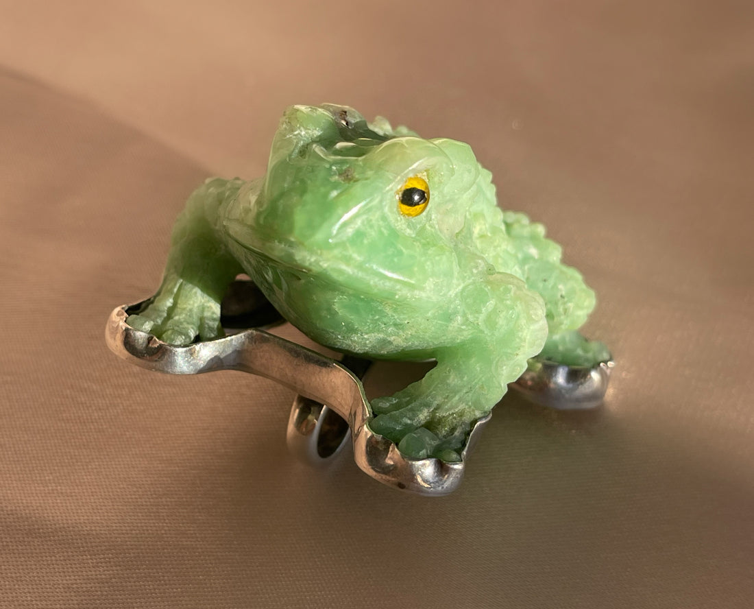 A vintage hand carved green jade frog with glass eyes set in sterling silver