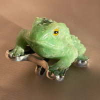 A vintage hand carved green jade frog with glass eyes set in sterling silver