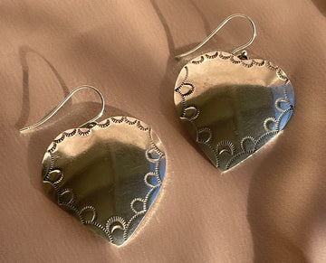 A pair of vintage sterling silver Native American Navajo hand stamped heart shaped dangle earrings
