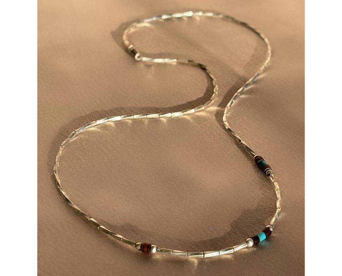 A Native American Navajo sterling silver liquid silver beaded necklace with wood beads and turquoise beads