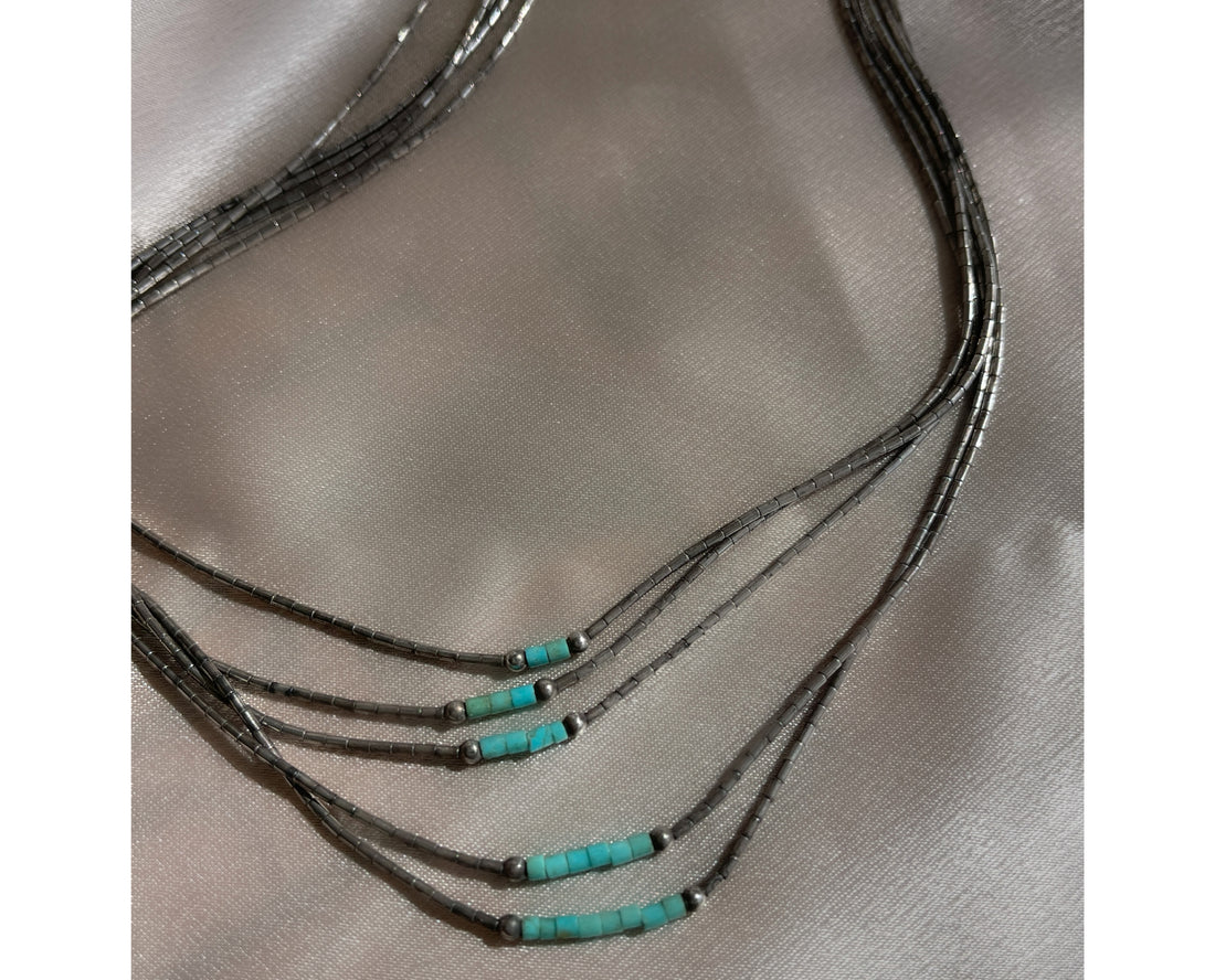 A five strand Native American Navajo vintage liquid silver necklace with sterling silver beads and turquoise