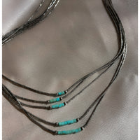 A five strand Native American Navajo vintage liquid silver necklace with sterling silver beads and turquoise