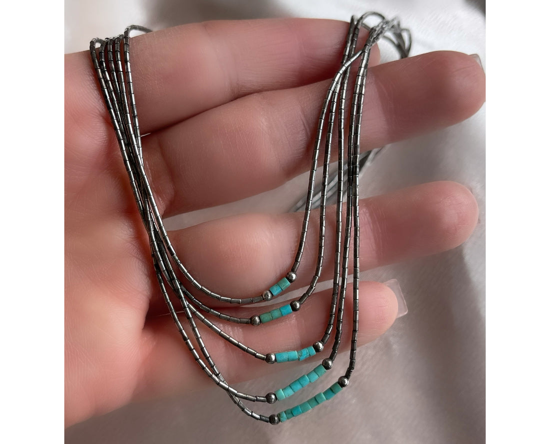 A five strand Native American Navajo vintage liquid silver necklace with sterling silver beads and turquoise