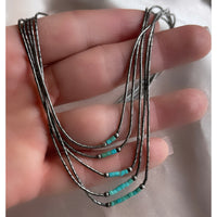 A five strand Native American Navajo vintage liquid silver necklace with sterling silver beads and turquoise