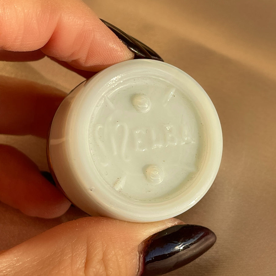Bottom of a white milk glass Melba cosmetics vintage jar