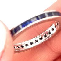 A 14k white gold 2ctw modern blue sapphire eternity band ring