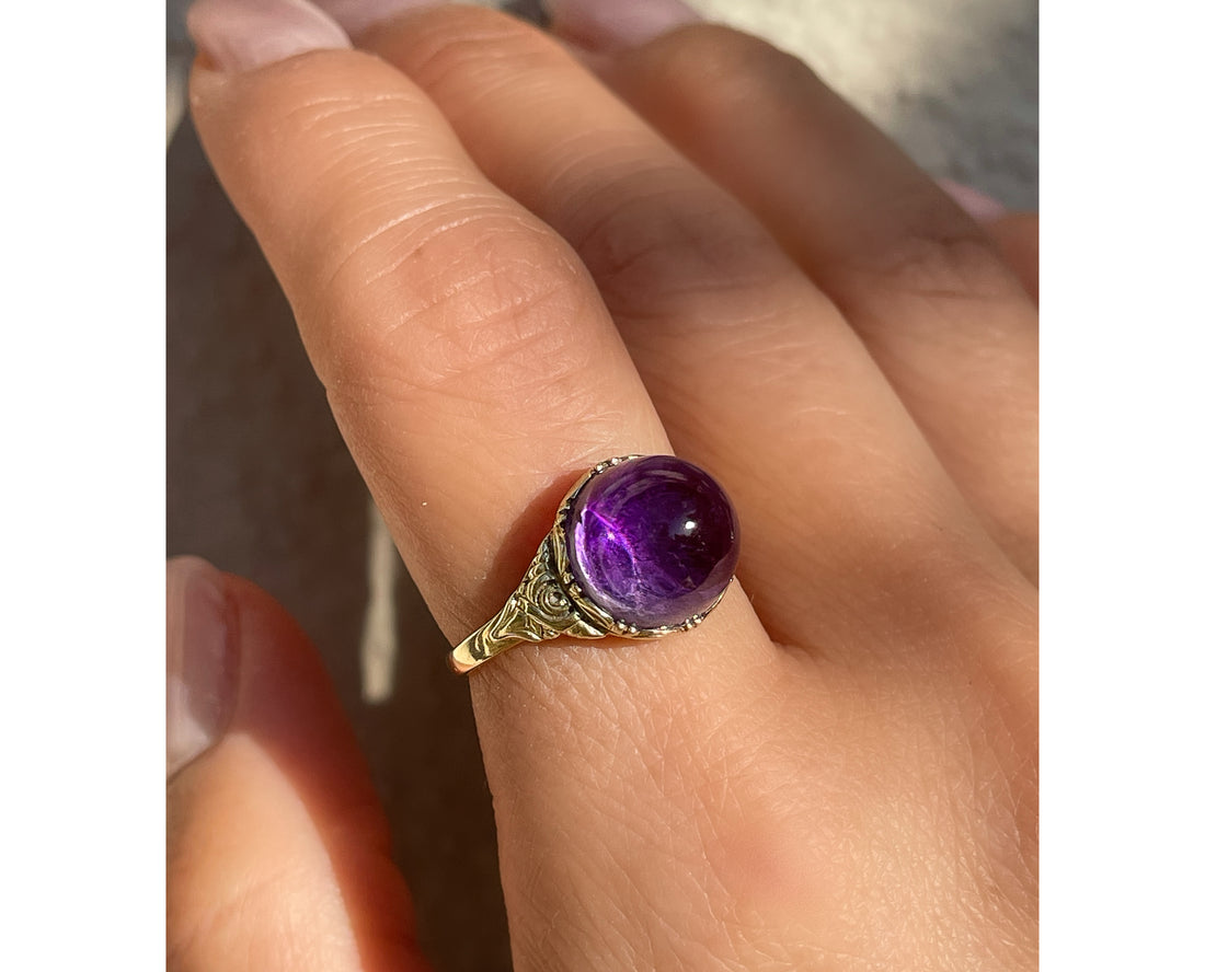 Antique Victorian sugarloaf cabochon amethyst ring with pie-crust bezel and repousse detail on shank in 14k yellow gold