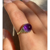 Antique Victorian sugarloaf cabochon amethyst ring with pie-crust bezel and repousse detail on shank in 14k yellow gold