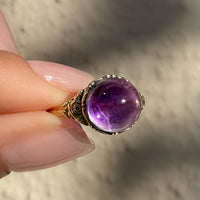 Antique Victorian sugarloaf cabochon amethyst ring with pie-crust bezel and repousse detail on shank in 14k yellow gold