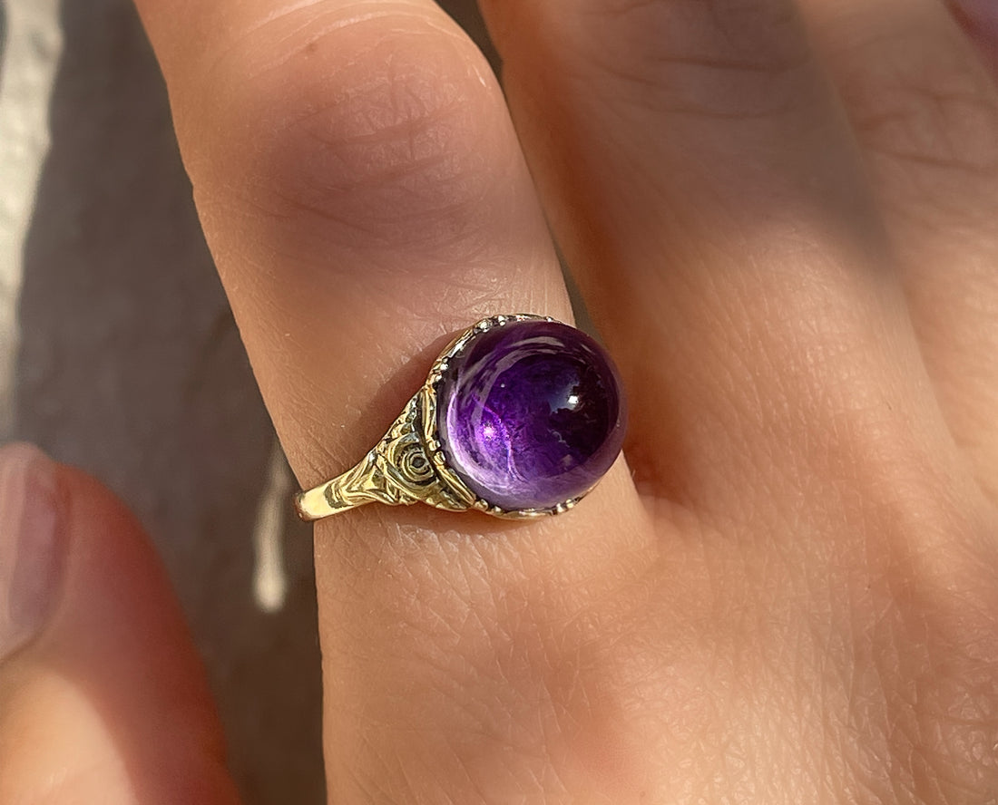 Antique Victorian sugarloaf cabochon amethyst ring with pie-crust bezel and repousse detail on shank in 14k yellow gold