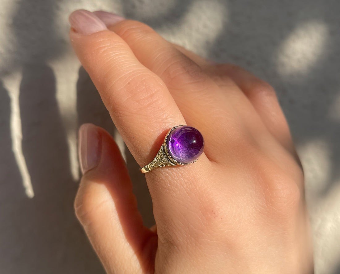 Antique Victorian sugarloaf cabochon amethyst ring with pie-crust bezel and repousse detail on shank in 14k yellow gold