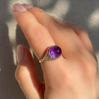 Antique Victorian sugarloaf cabochon amethyst ring with pie-crust bezel and repousse detail on shank in 14k yellow gold