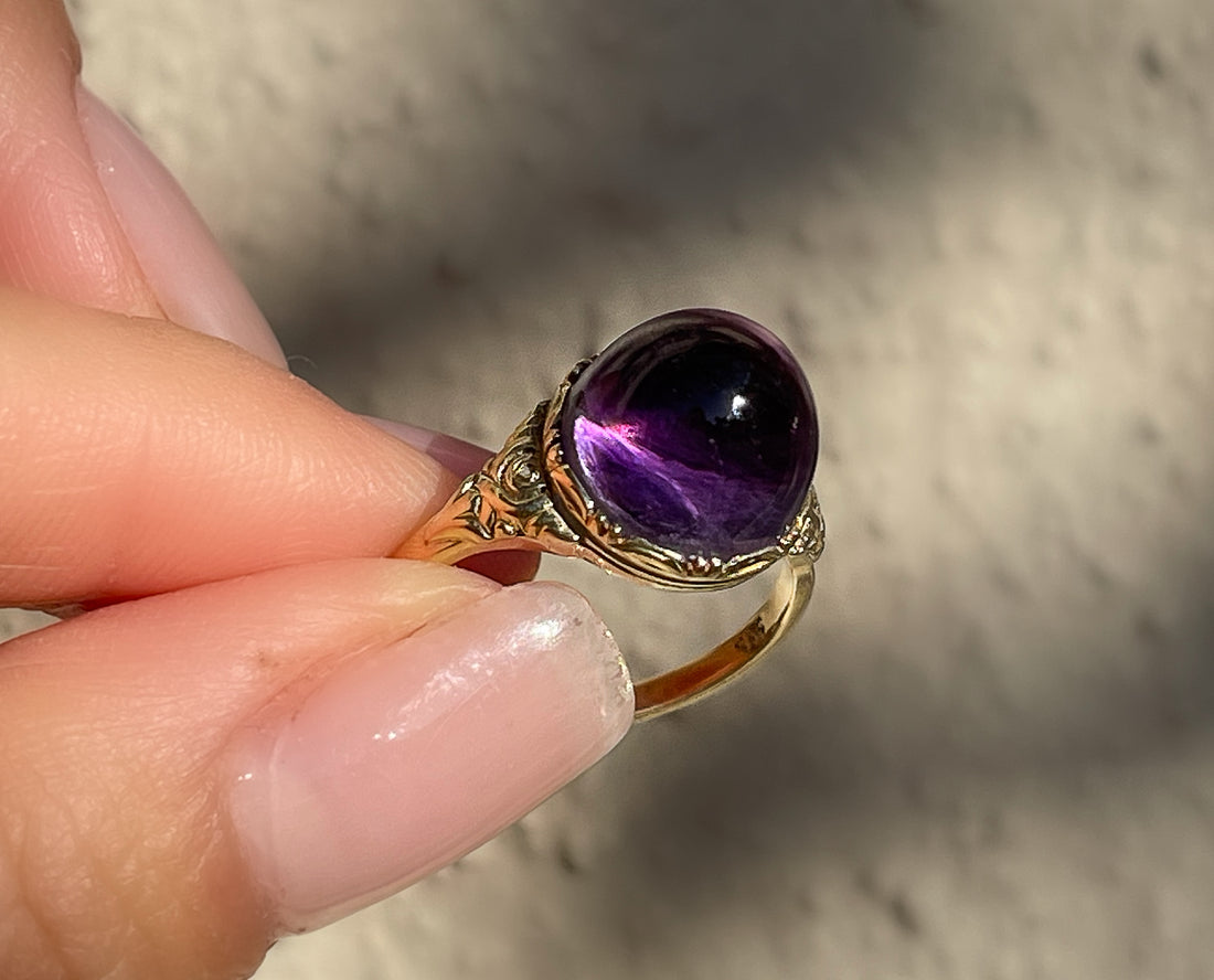 Antique Victorian sugarloaf cabochon amethyst ring with pie-crust bezel and repousse detail on shank in 14k yellow gold