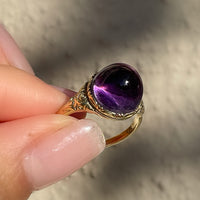 Antique Victorian sugarloaf cabochon amethyst ring with pie-crust bezel and repousse detail on shank in 14k yellow gold