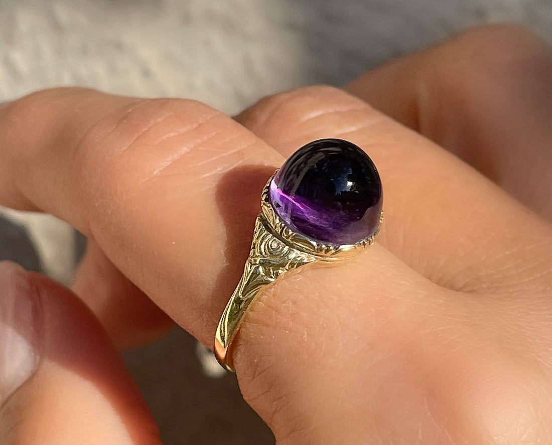 Antique Victorian sugarloaf cabochon amethyst ring with pie-crust bezel and repousse detail on shank in 14k yellow gold