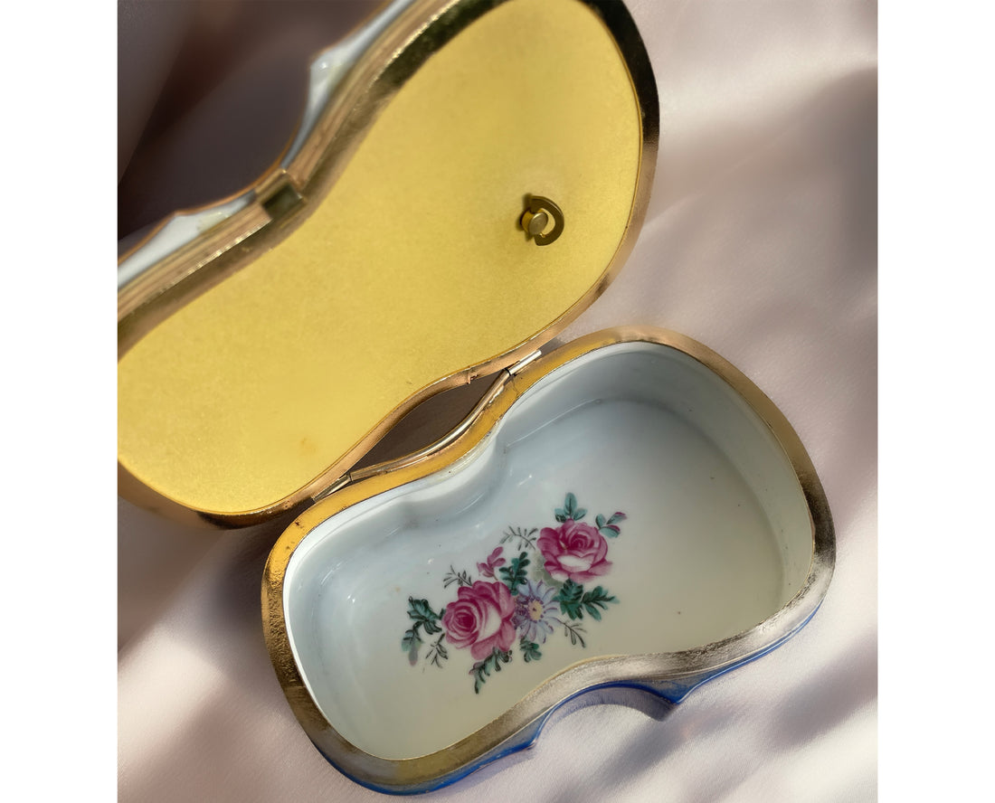 A 1980s eighties violin shaped lidded jewelry trinket box with a painting of a couple on the lid